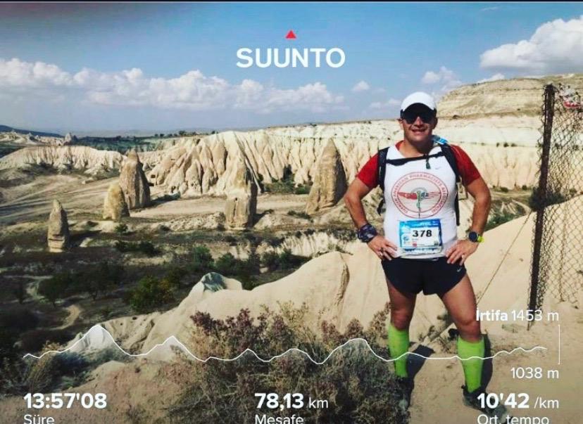 Erden Giritli after a long trail run in Cappadocia with rock formations in the background