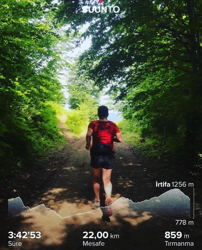 Erden Giritli running on a forest trail during an endurance session