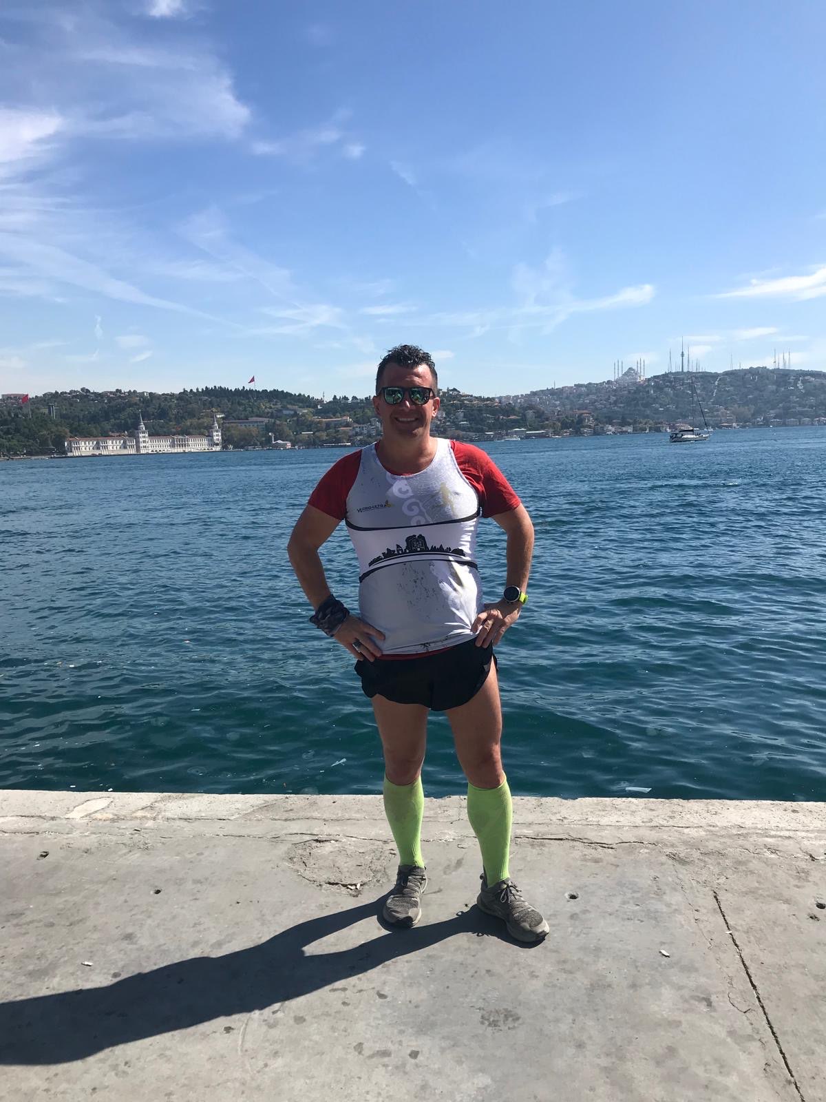 Erden Giritli by the Bosphorus shoreline, reflecting his running coach and endurance sport experience