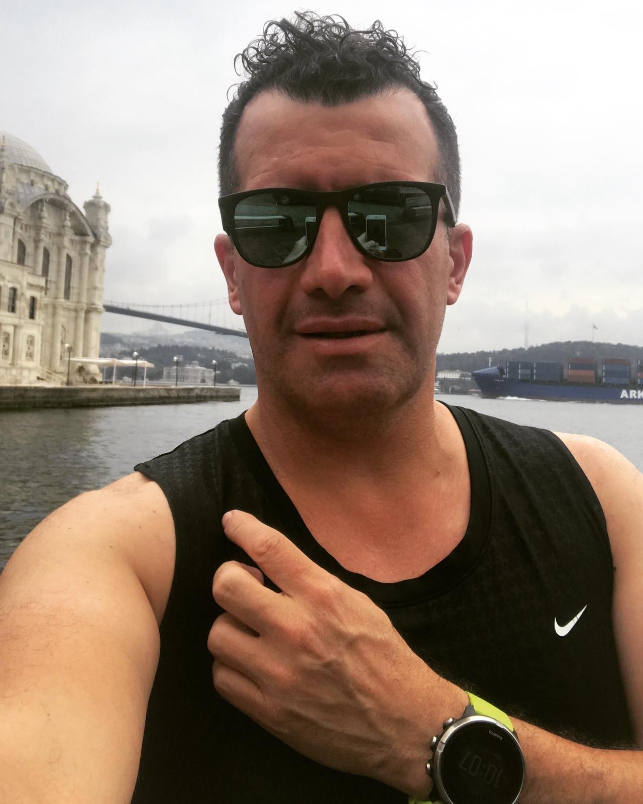 Erden Giritli taking a selfie along the Bosphorus shoreline, reflecting his endurance coach and running coach experience