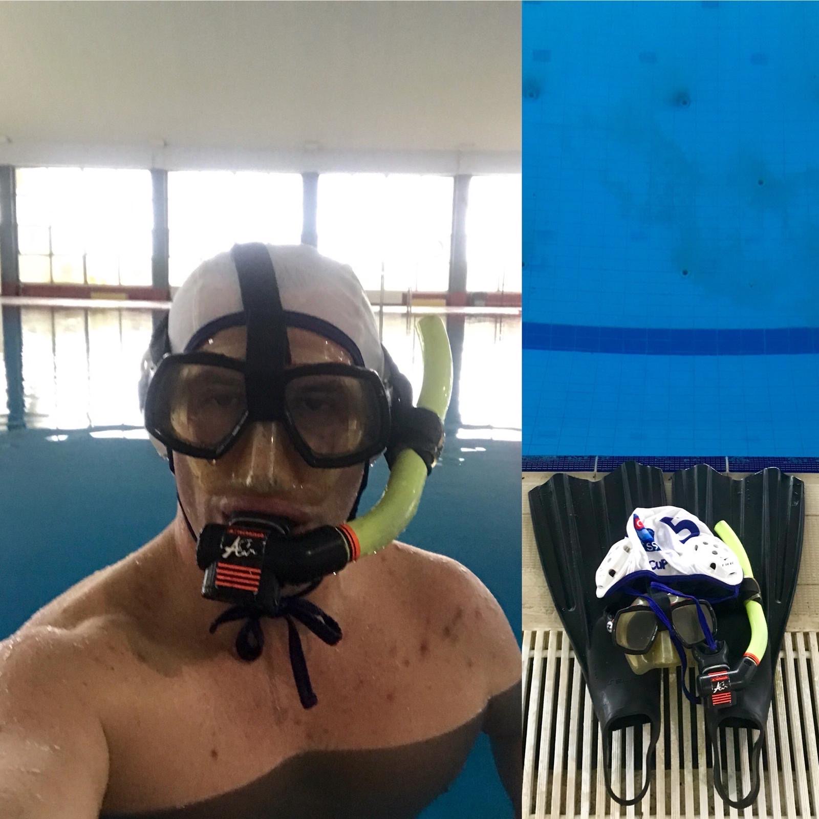 Erden Giritli in an indoor pool with snorkel gear, reflecting his swimming coach identity
