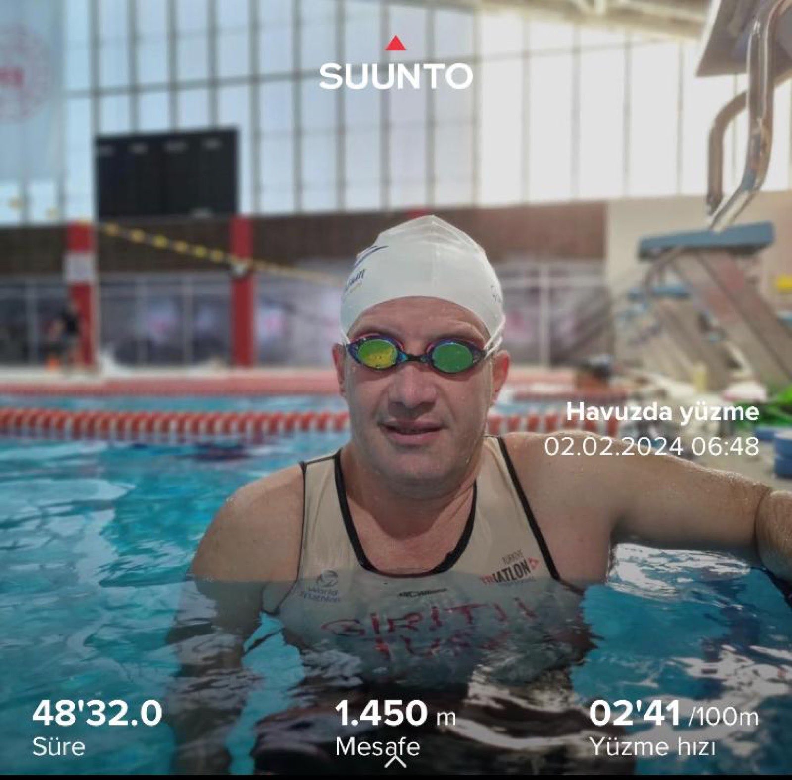 Erden Giritli during a pool recovery session, reflecting his swimming coach identity
