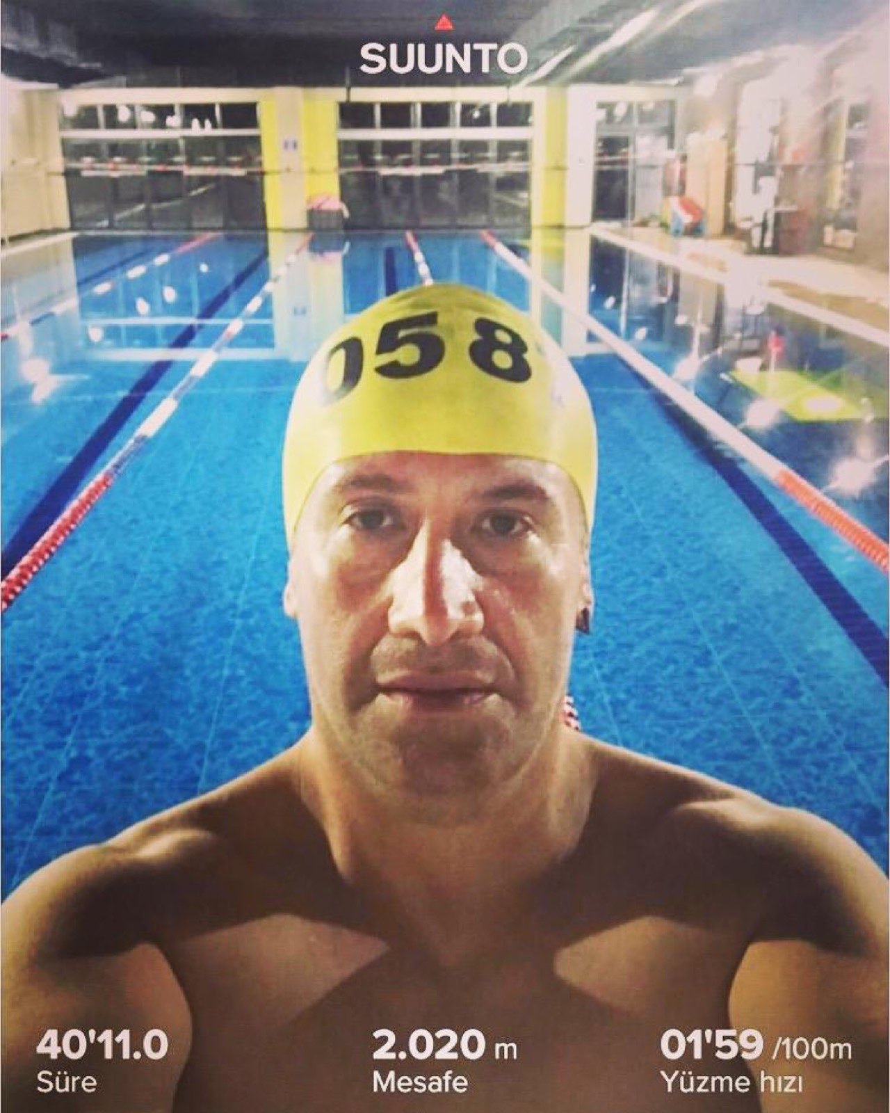 Erden Giritli taking a selfie after an indoor pool session, reflecting his swimming coach identity