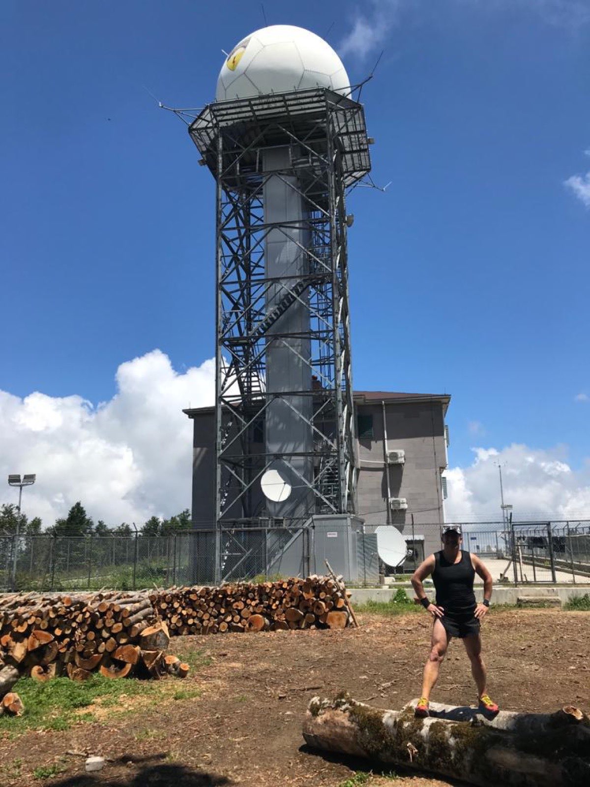 Erden Giritli near a mountain radar station, reflecting his trail running coach experience