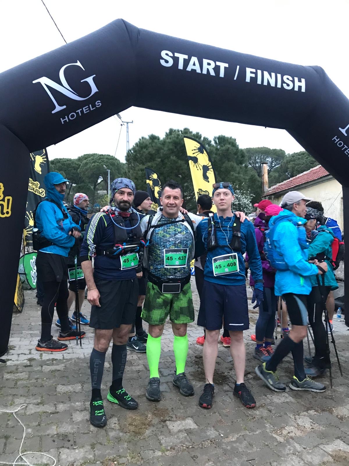 Erden Giritli with fellow racers at a start finish area, showing his endurance coach experience