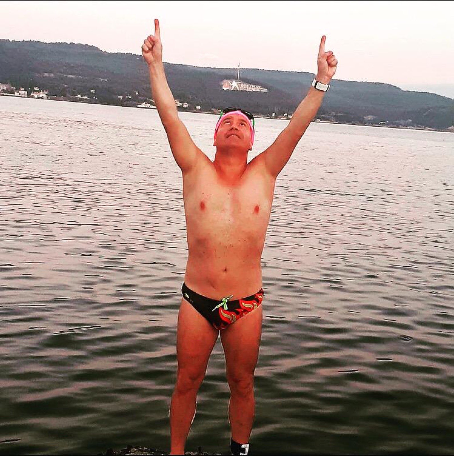 Erden Giritli celebrating after an open water swim, reflecting his swimming coach identity