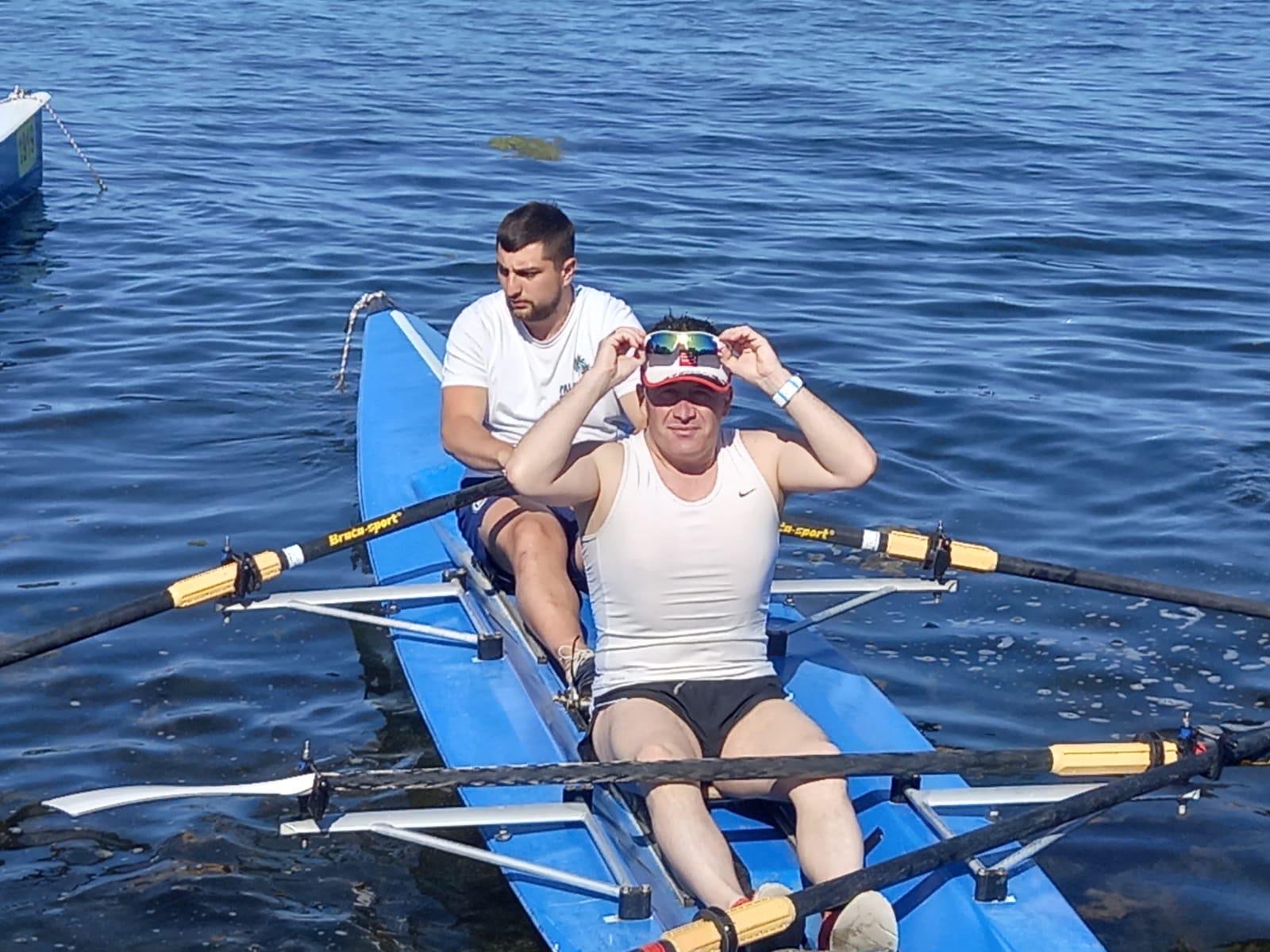 Erden Giritli training with a partner in a rowing boat, reflecting his endurance coach experience