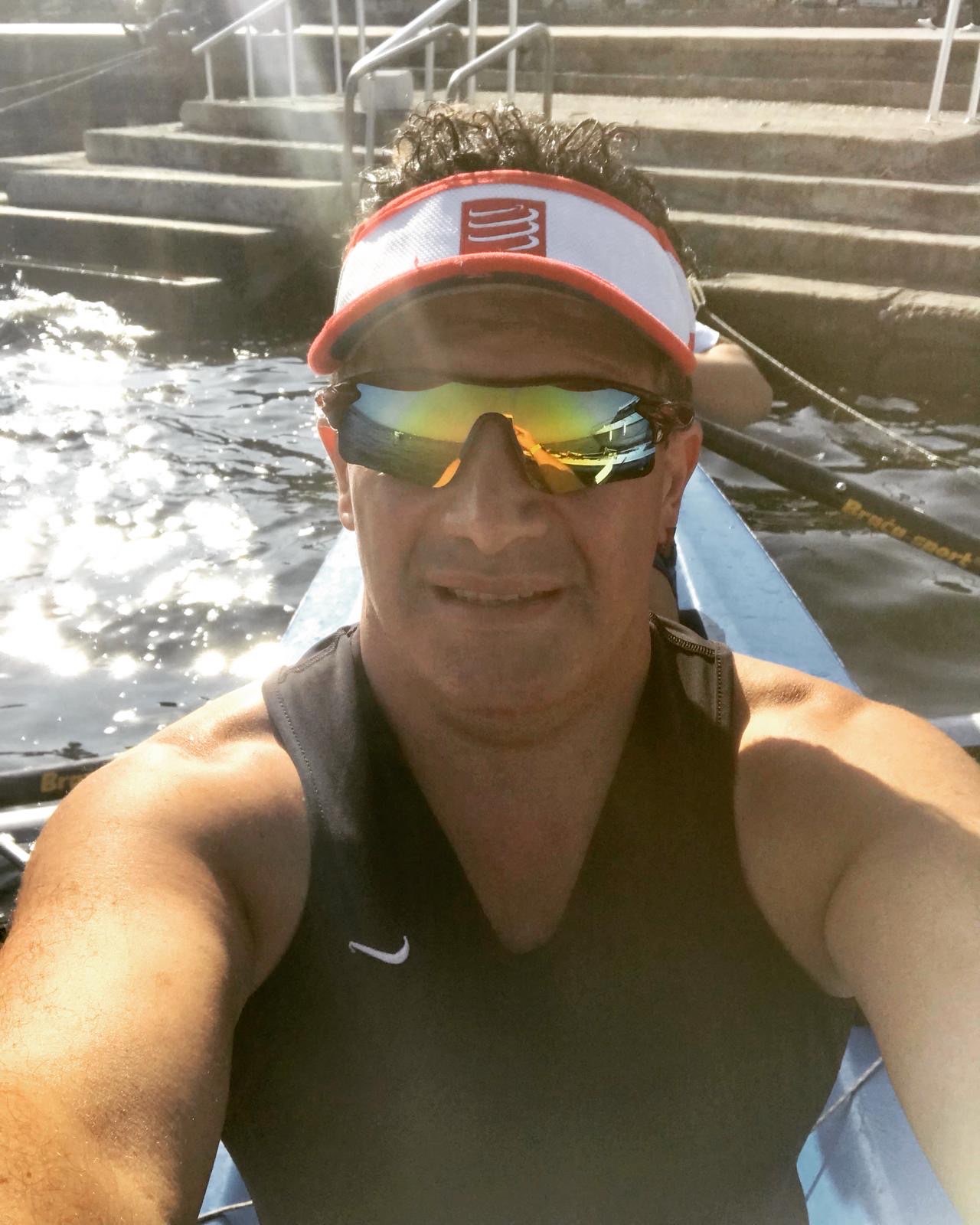 Erden Giritli taking a selfie in a rowing boat on the water, showing his endurance coach experience