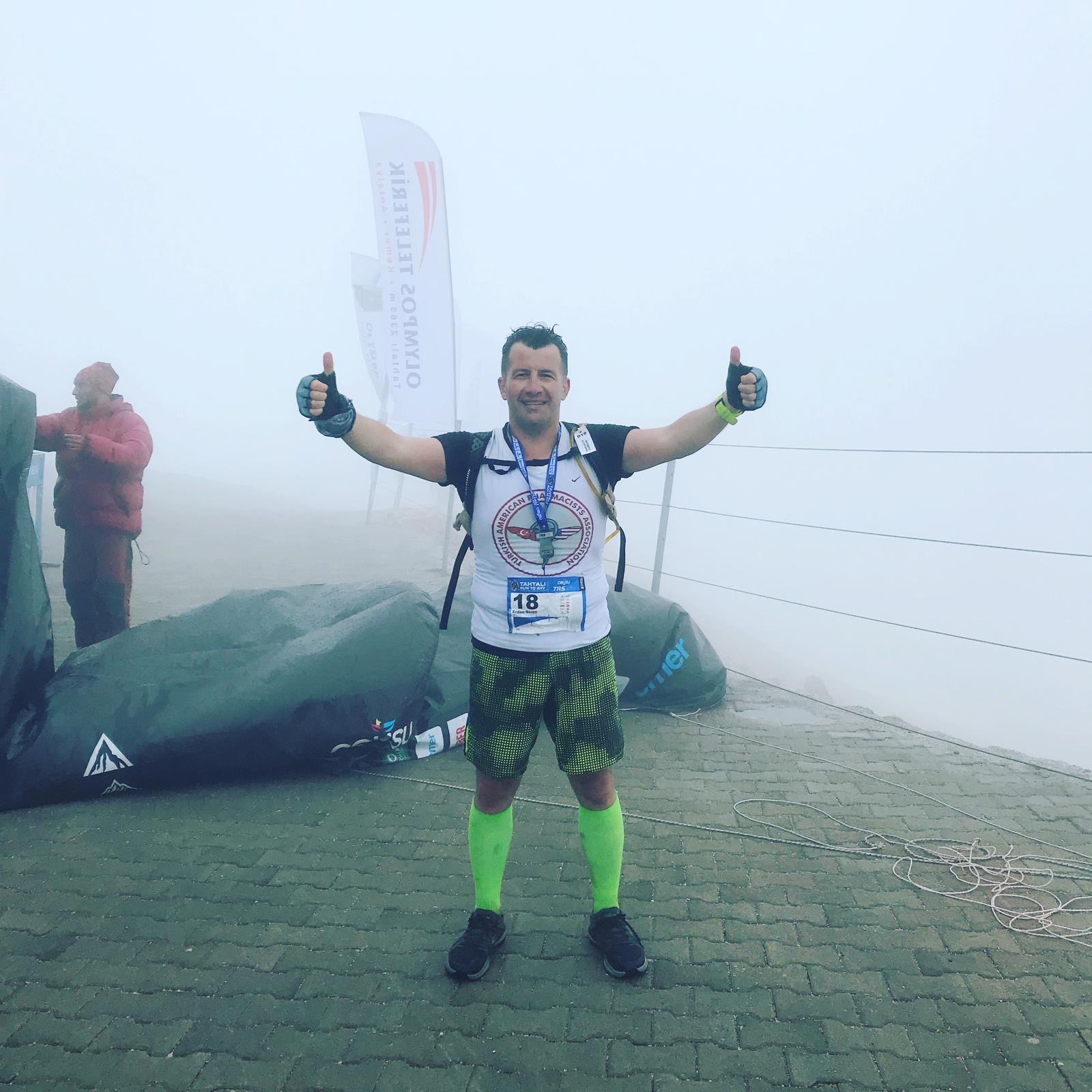 Erden Giritli at a foggy finish point, showing his trail running and endurance coach experience