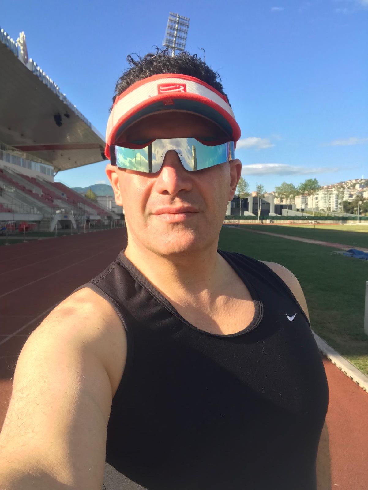 Erden Giritli taking a selfie on an athletics track, reflecting his personal trainer and fitness coach identity