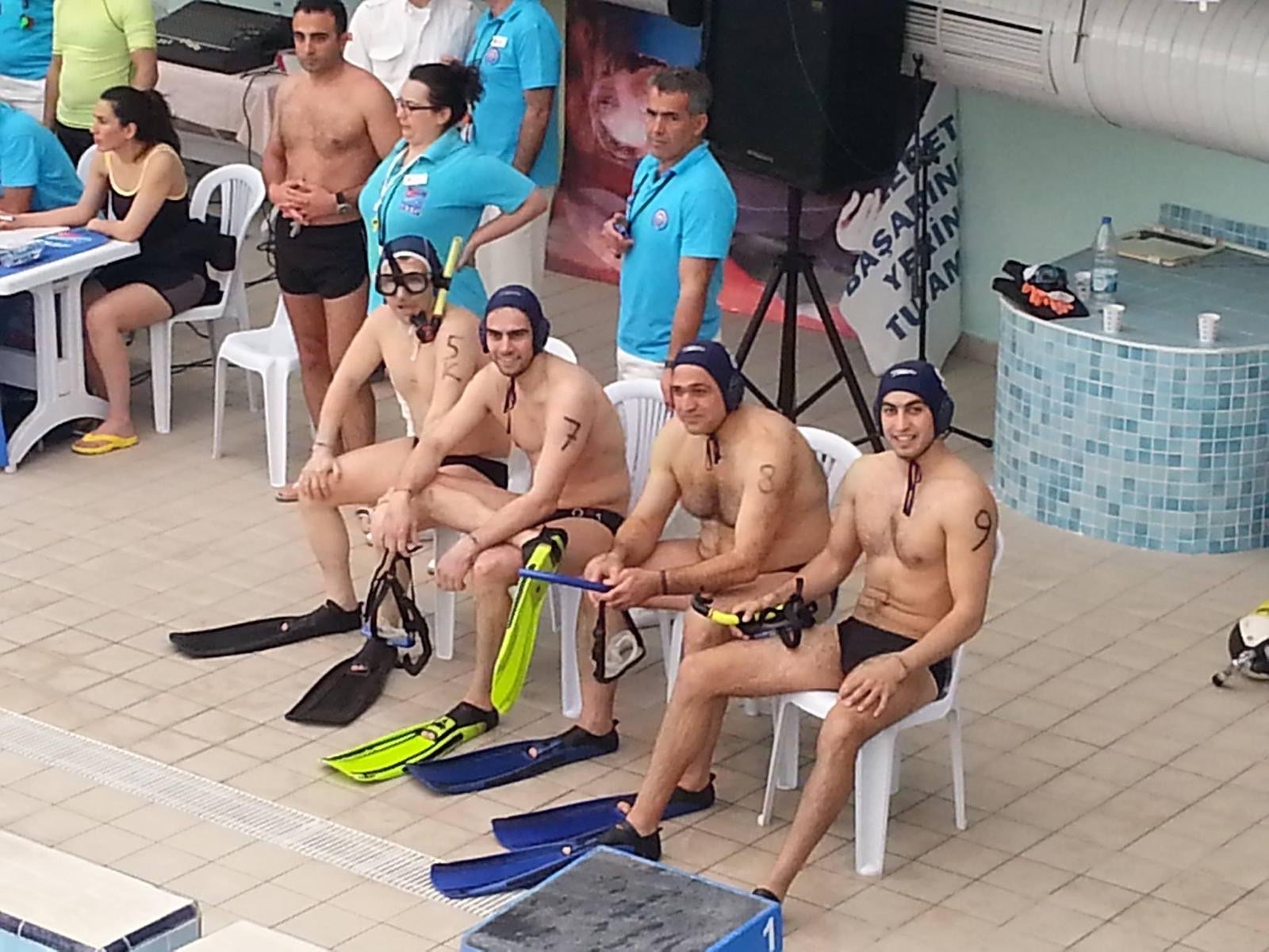 Erden Giritli at poolside during an underwater hockey session, showing field experience that supports his swimming coach identity